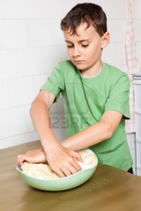 9502191 little boy kneading pizza or bread dough 150x150