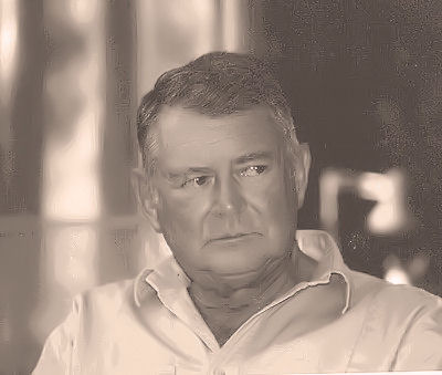 photograph: Dennie Briggs black and white head and shoulders photograph, glancing to one side